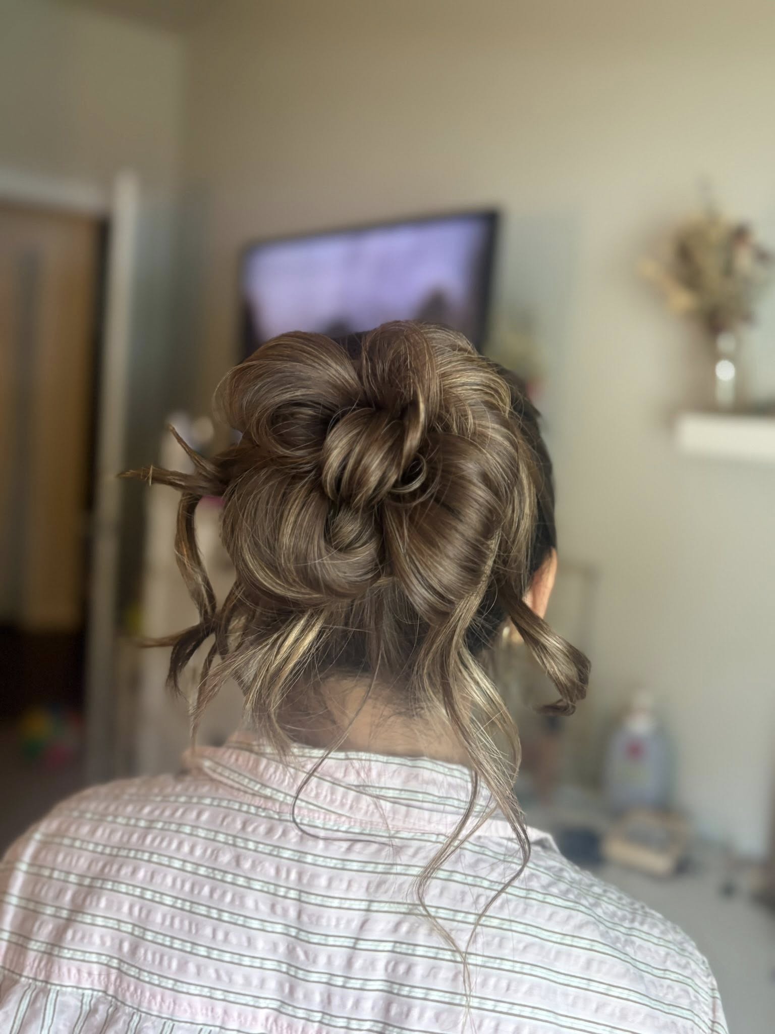 Special-occasion updo with face-framing tendrils